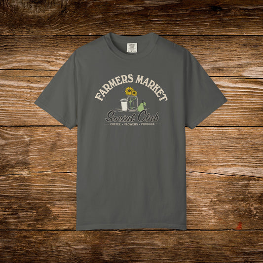 Gray t-shirt with text on a wooden surface