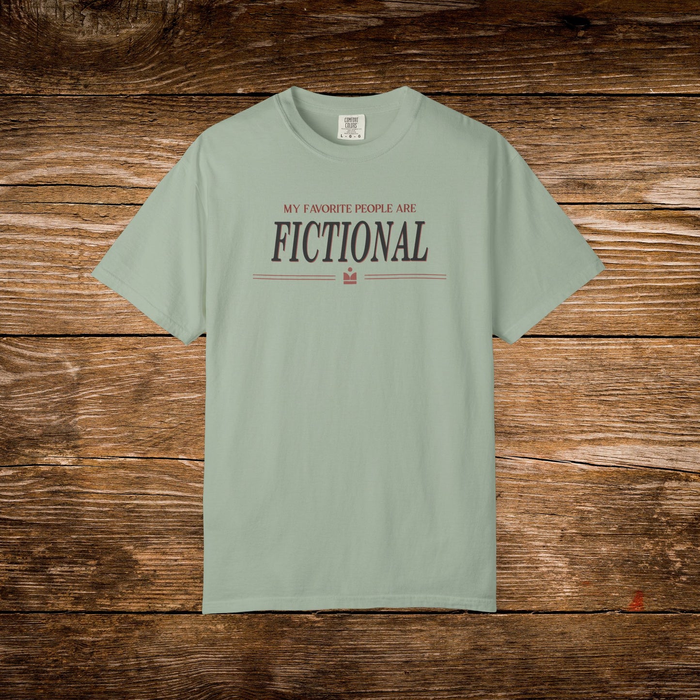 Sage green t-shirt with text on a wooden background