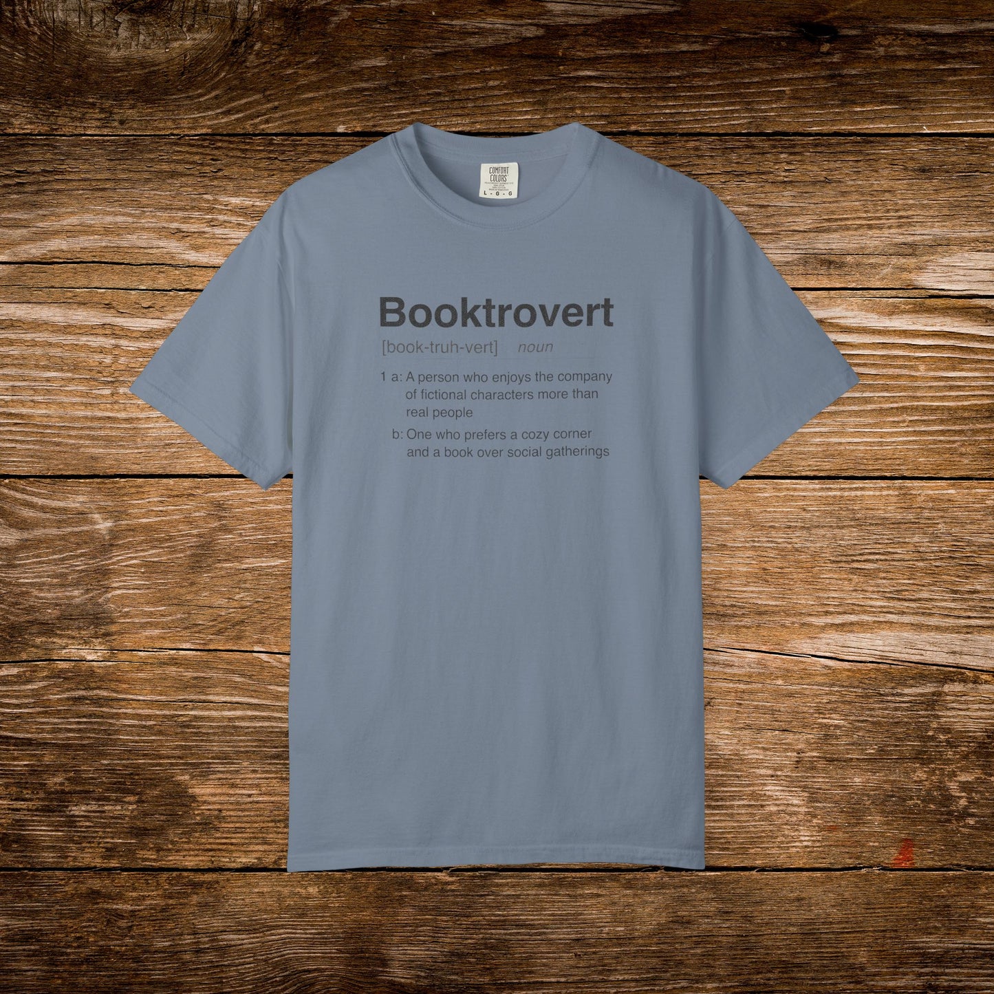 Booktrovert dictionary definition design printed on a Blue Jean Comfort Colors T-shirt.