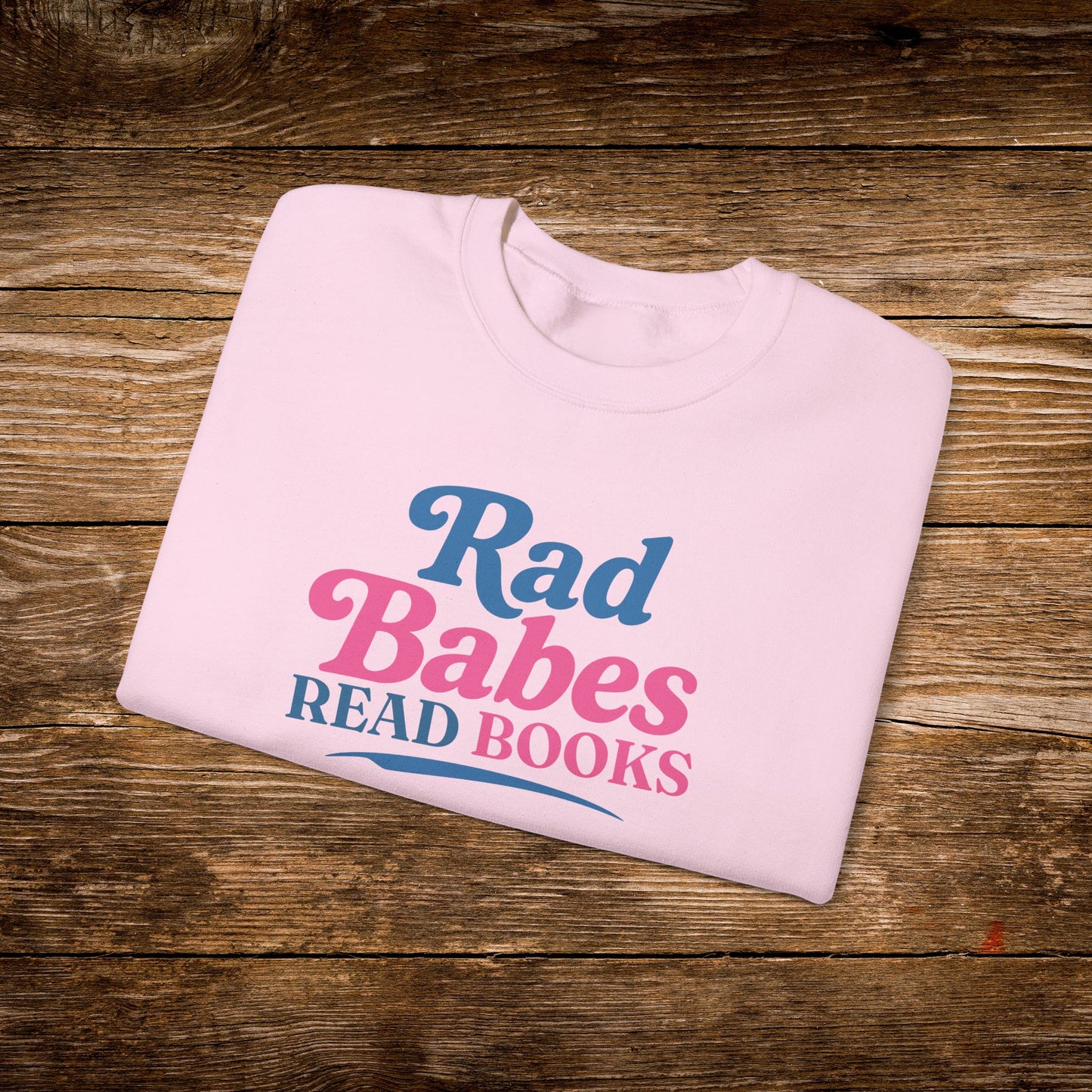 12. Light Pink Folded
    Folded light pink Rad Babes Read Books graphic sweatshirt.