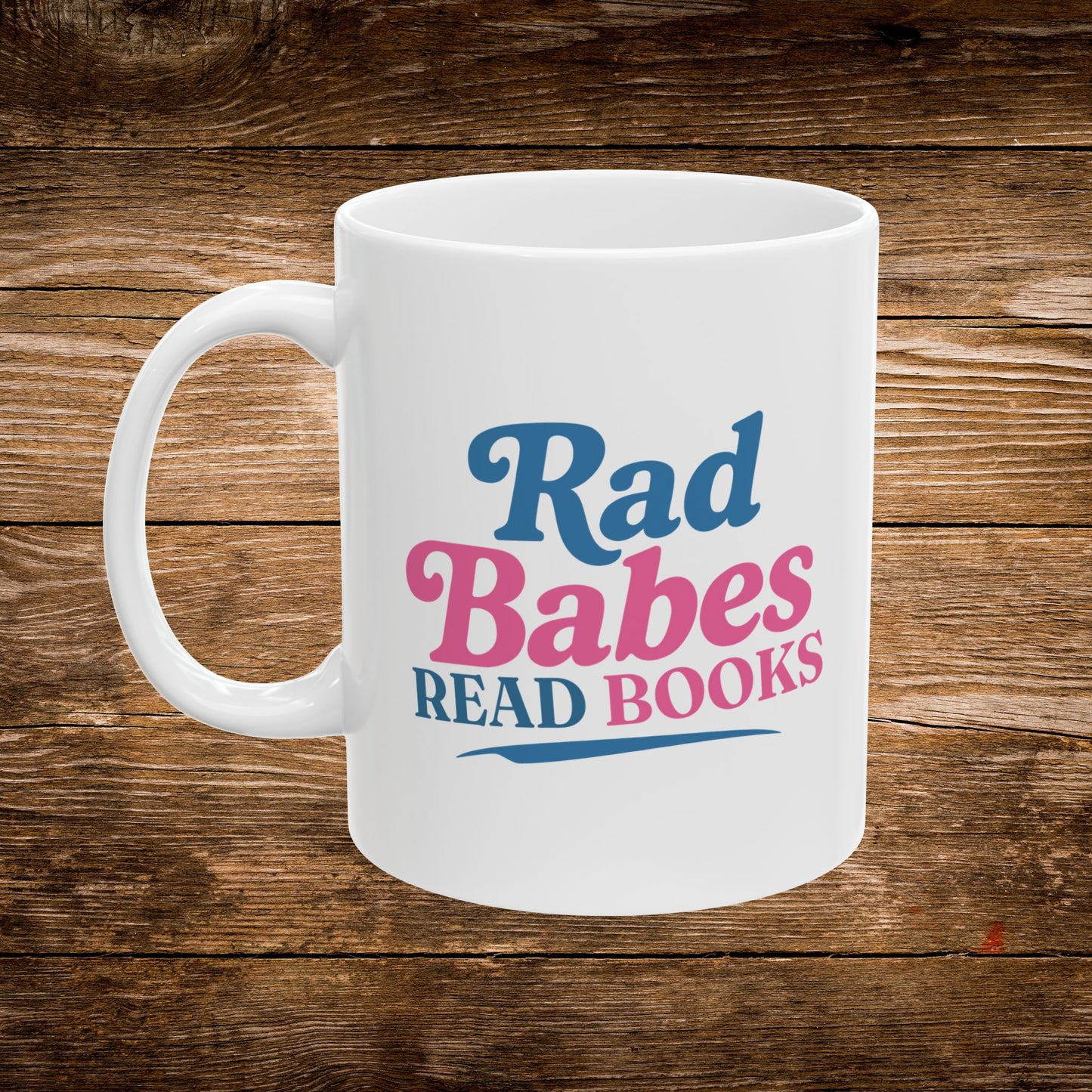 1. Front View
    White ceramic Rad Babes Read Books coffee mug showing the front design.