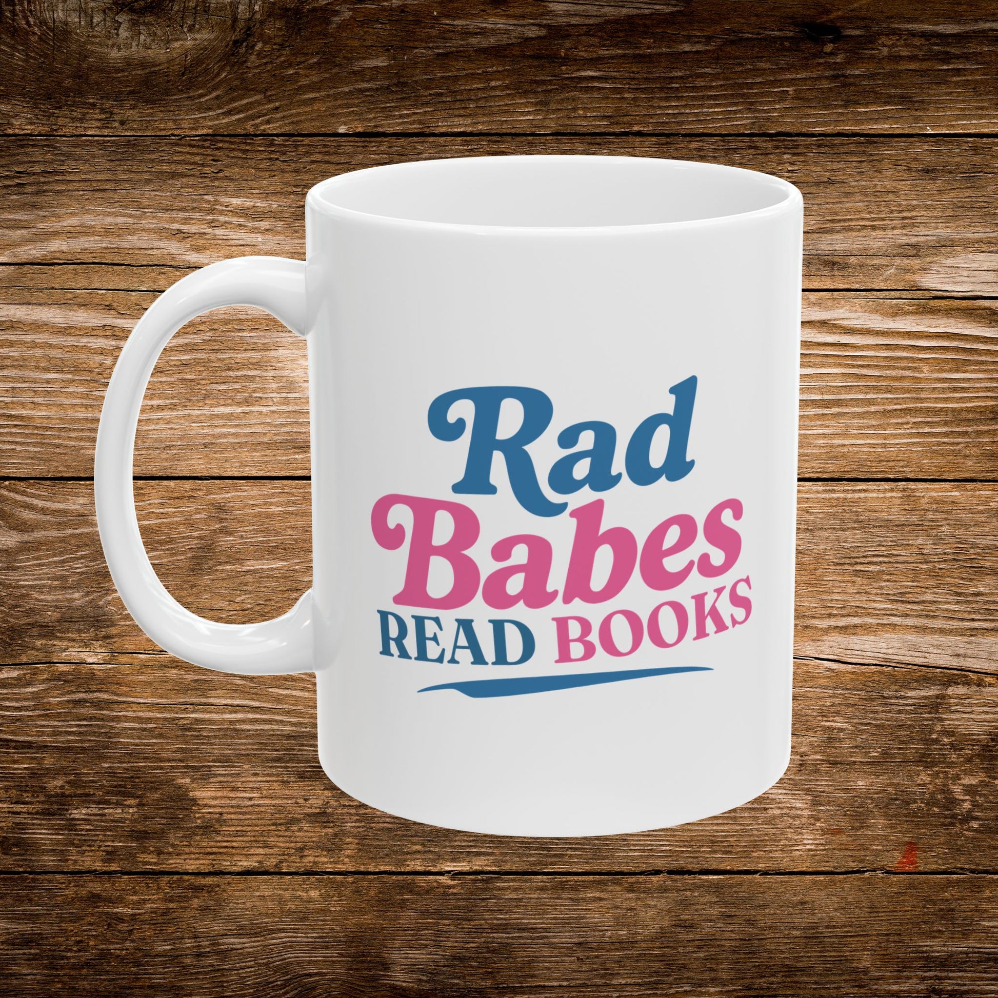1. Front View
    White ceramic Rad Babes Read Books coffee mug showing the front design.
