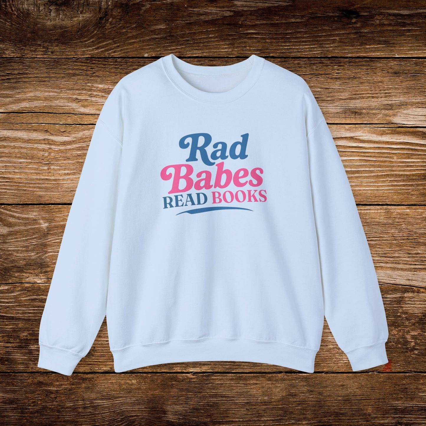 9. Light Blue Sweatshirt
    Rad Babes Read Books graphic sweatshirt shown on a light blue crewneck.