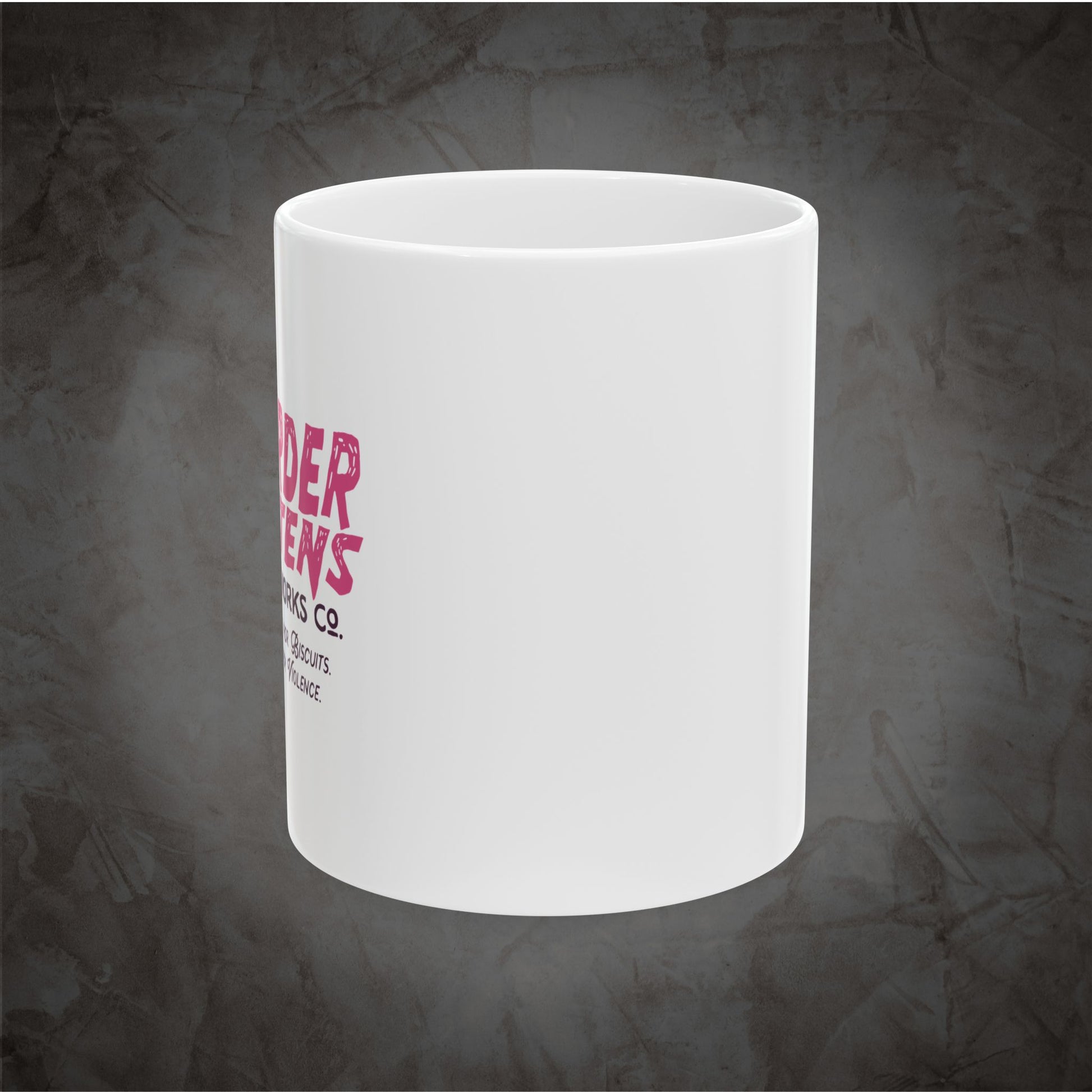 A white ceramic mug with a pink and black printed logo on the side, shown against a dark textured gray background.