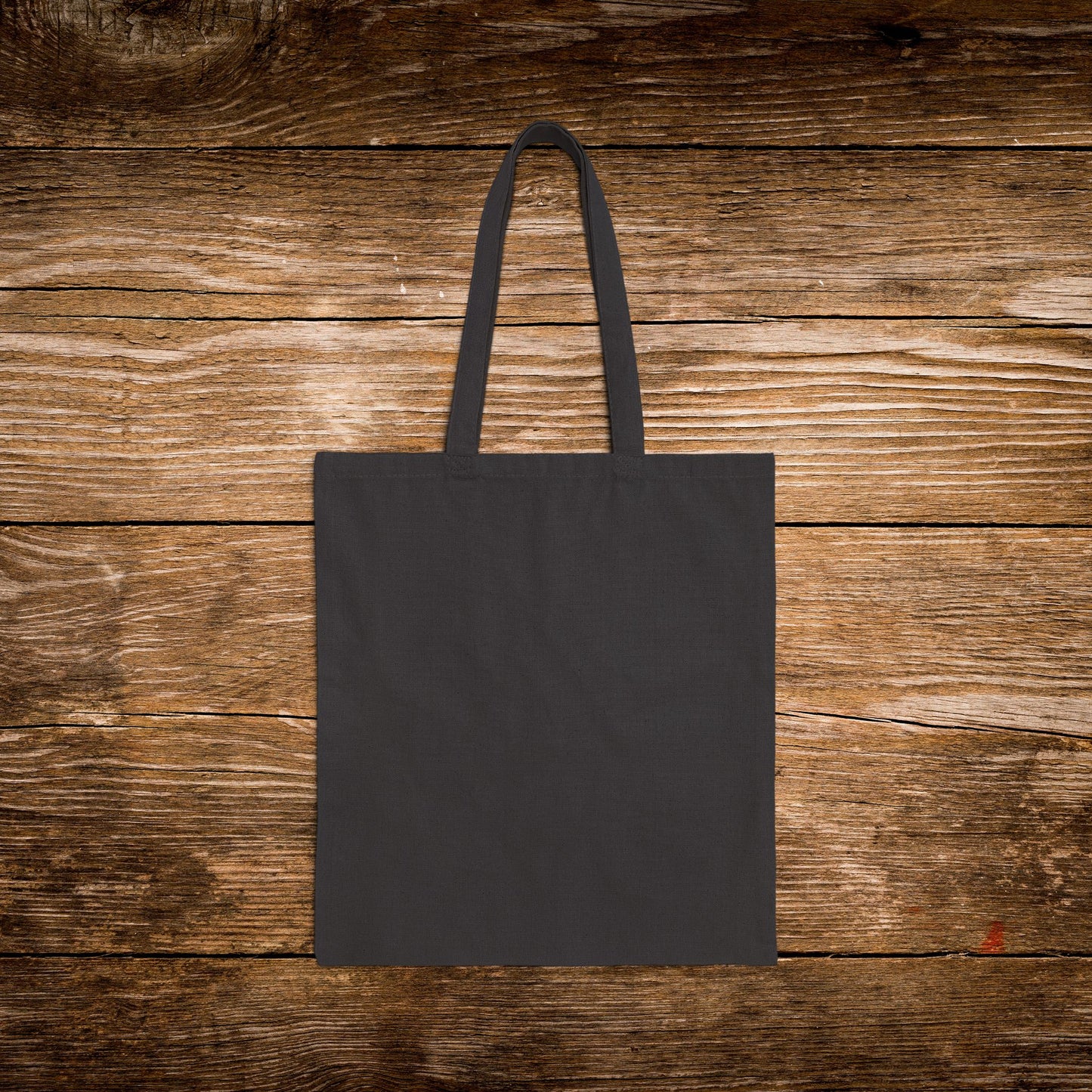 Black tote bag on a wooden surface