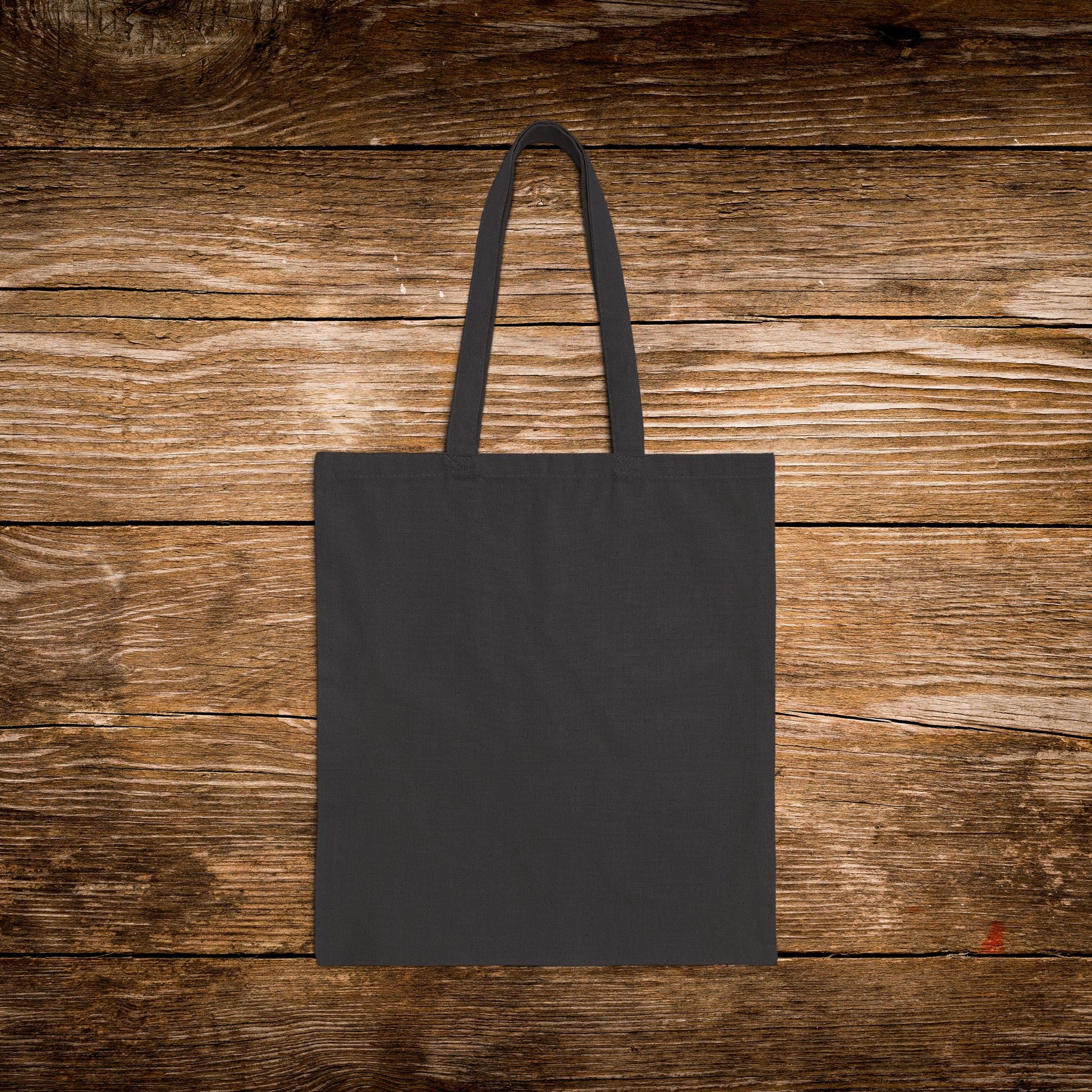 Black tote bag on a wooden surface