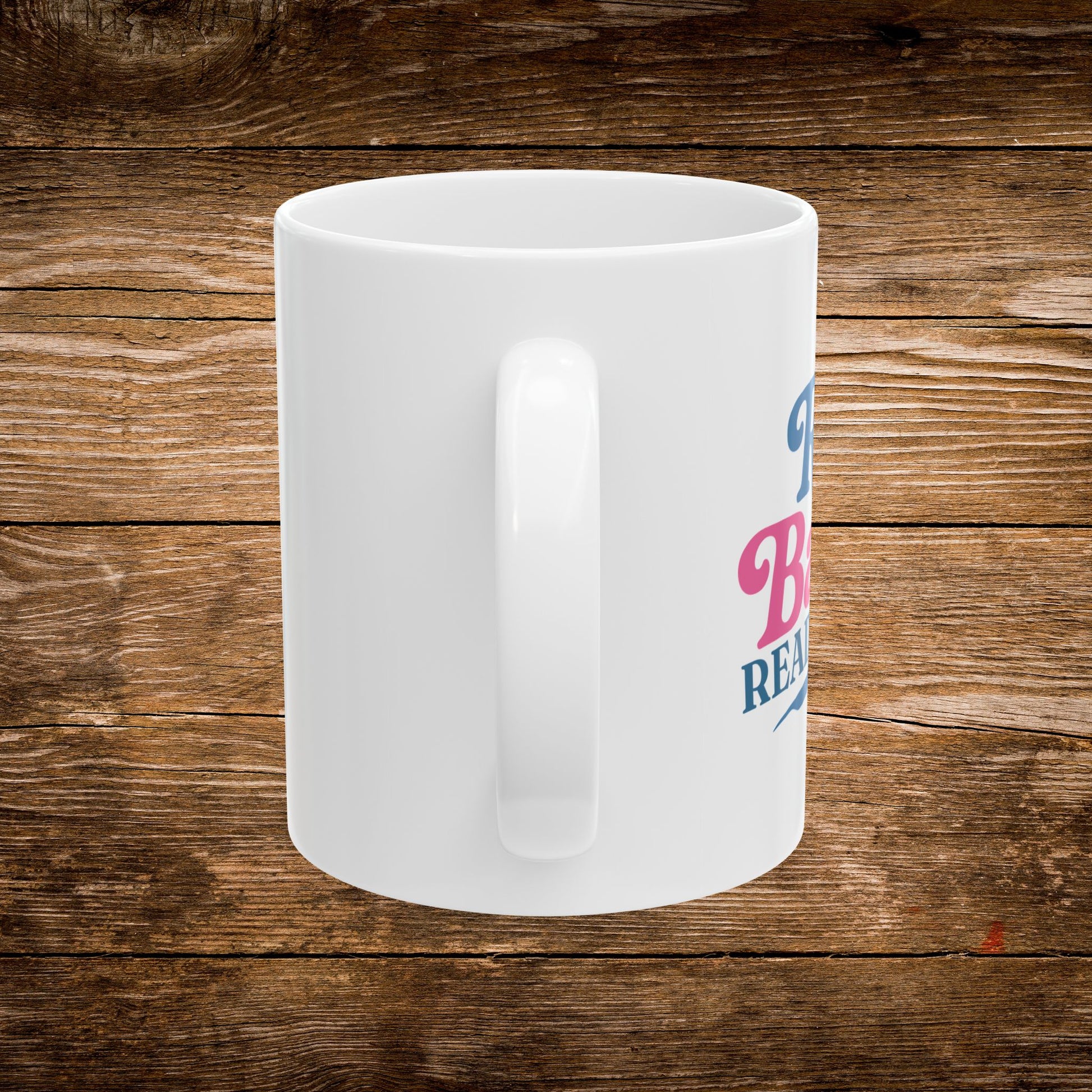 4. Back View
    White ceramic Rad Babes Read Books mug showing the back and handle.