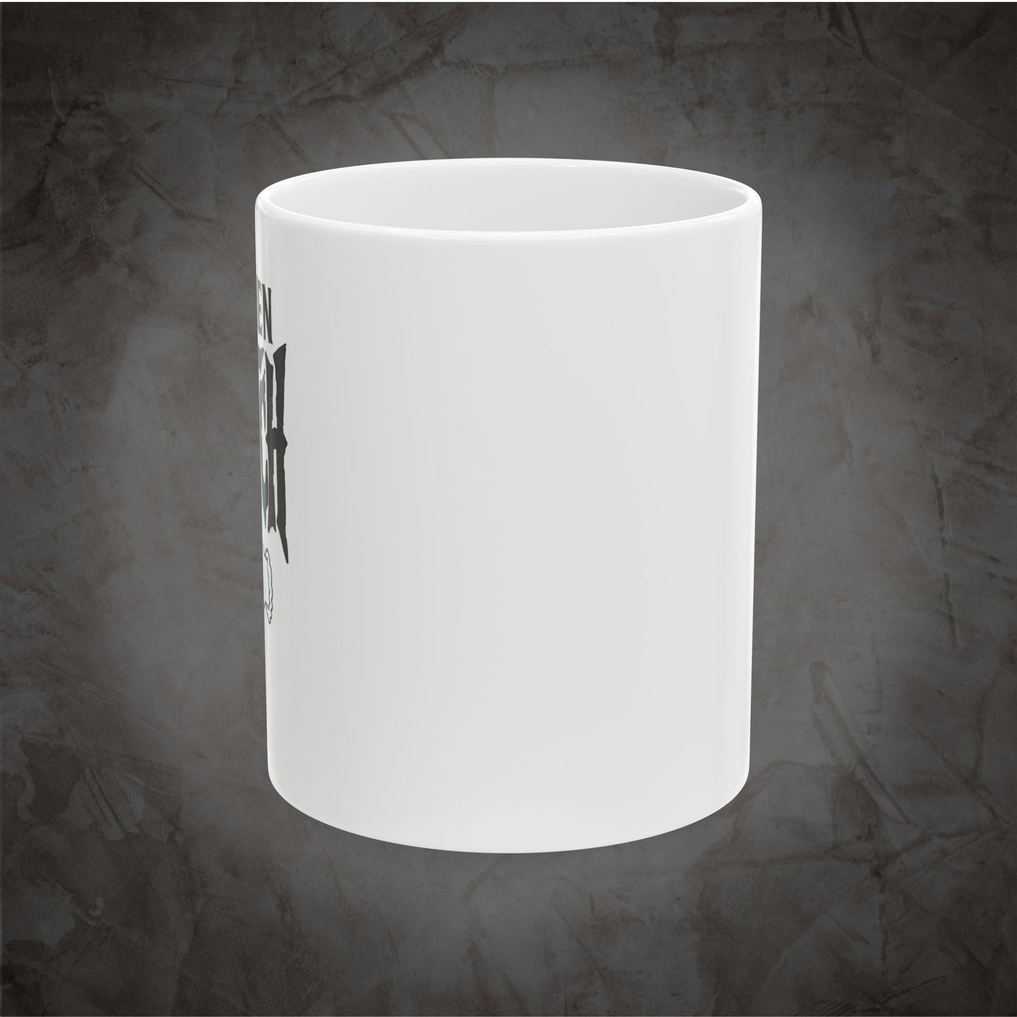 A white ceramic mug with a black graphic print on the side, shown against a textured dark gray background.