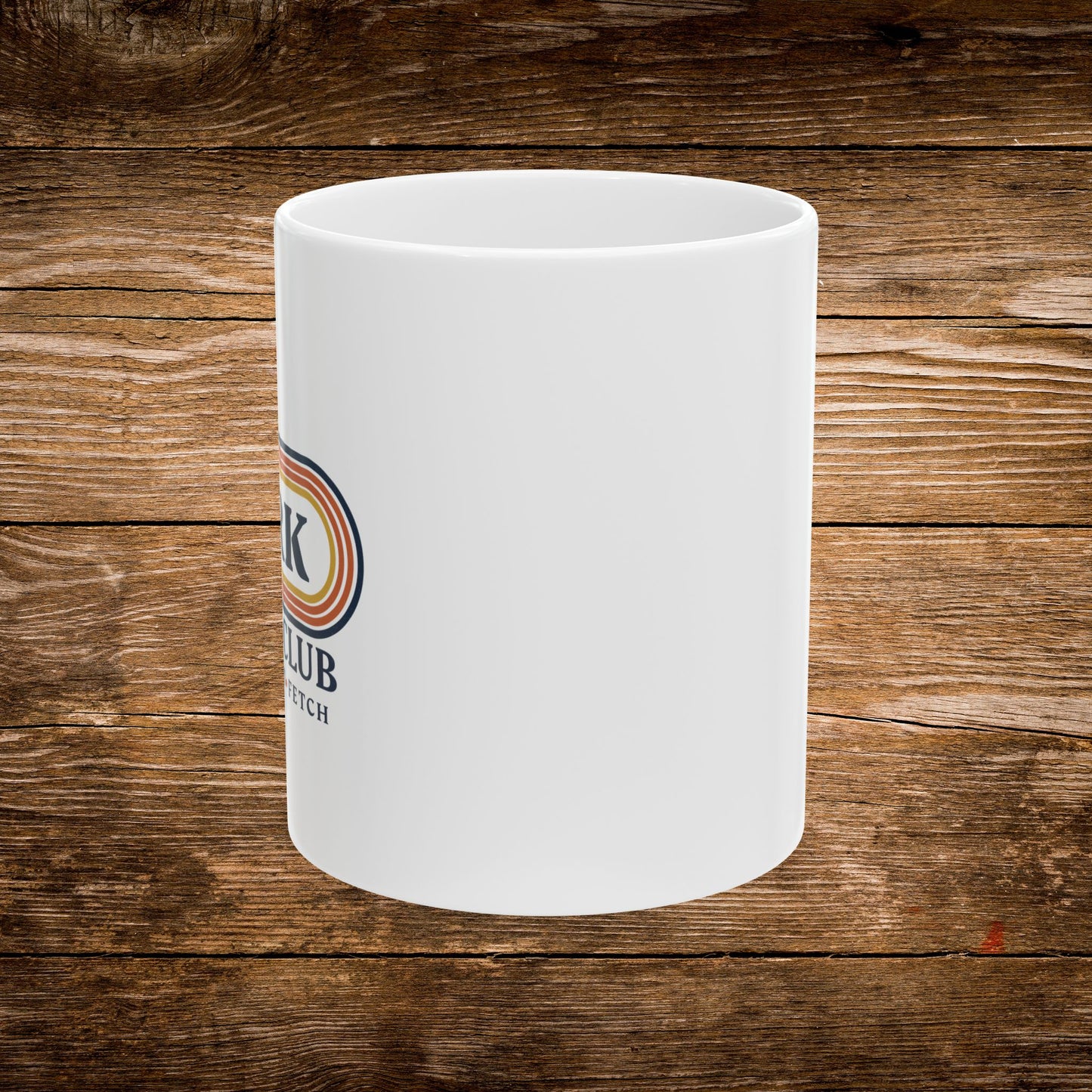 A white ceramic mug with a partial circular logo featuring red, orange, and blue stripes and the text 'K CLUB EST. 1959', shown on a rustic brown wooden plank background. The design text reads "Sniff, Flirt, Fetch."