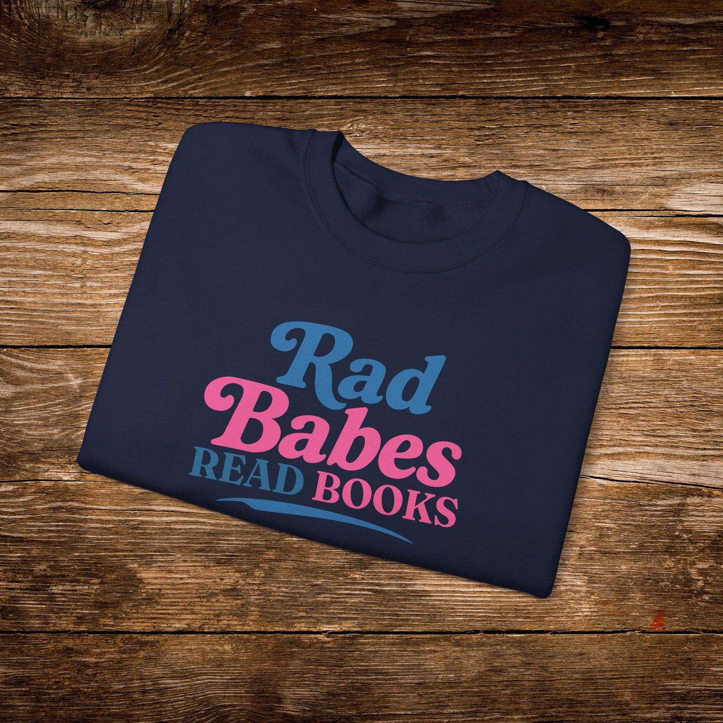 8. Navy Folded
    Folded navy Rad Babes Read Books graphic sweatshirt.