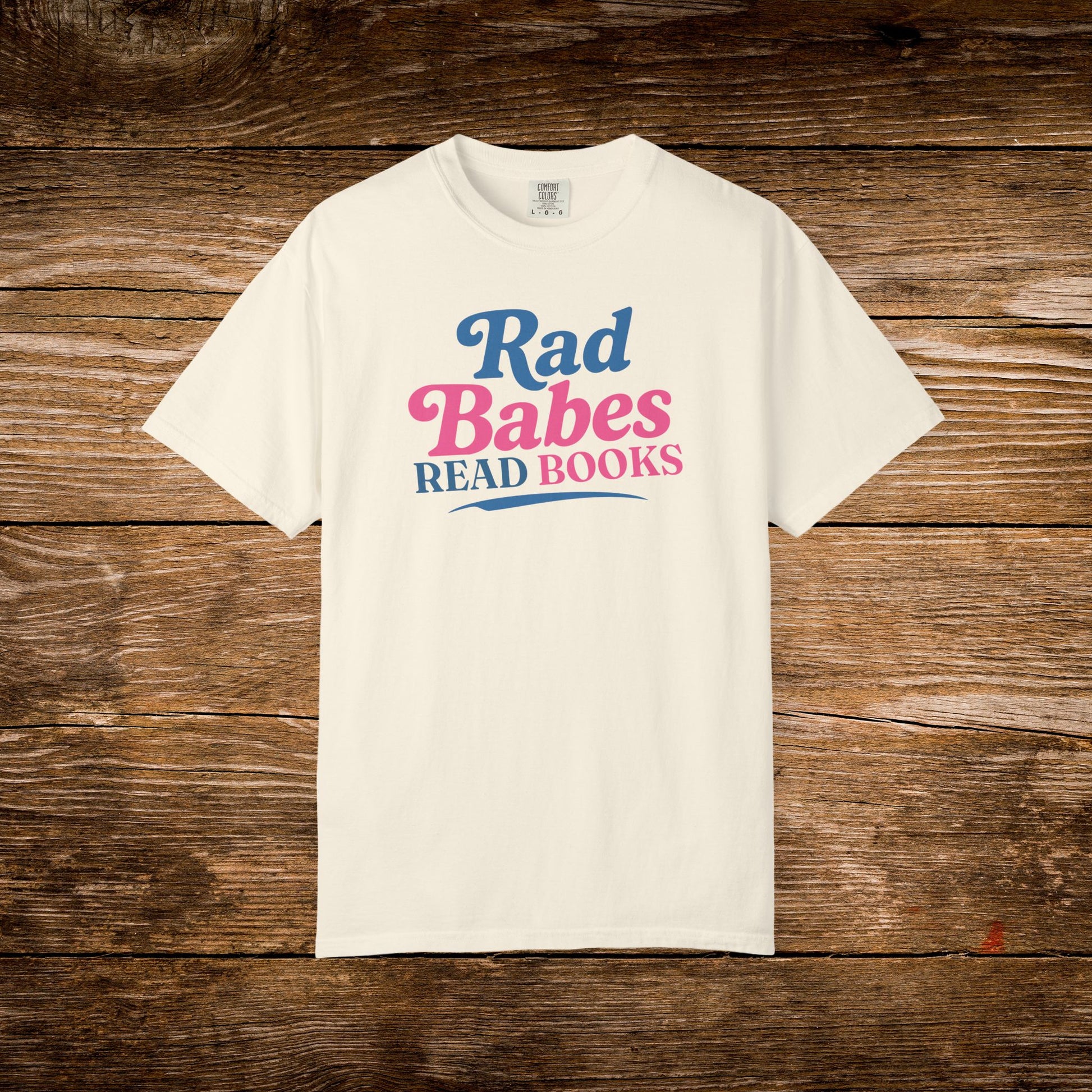 4. Front View
    Ivory Rad Babes Read Books graphic t-shirt on a wooden background.
