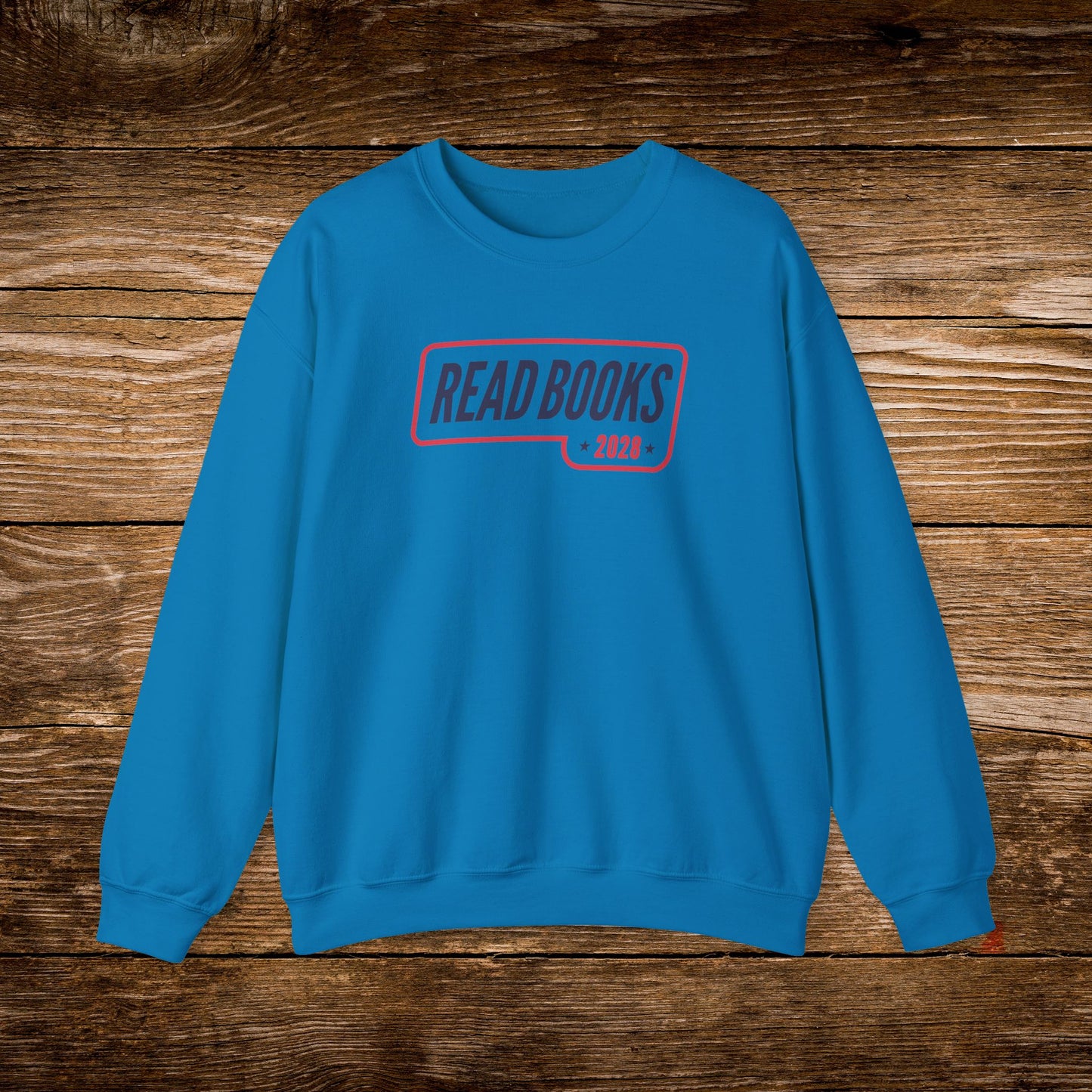 10. Sapphire Sweatshirt
    Read Books 2028 graphic sweatshirt shown on a sapphire crewneck.