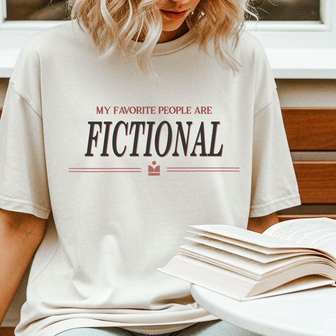 Person wearing a white t-shirt with 'My Favorite People Are Fictional' text, sitting on a wooden bench.