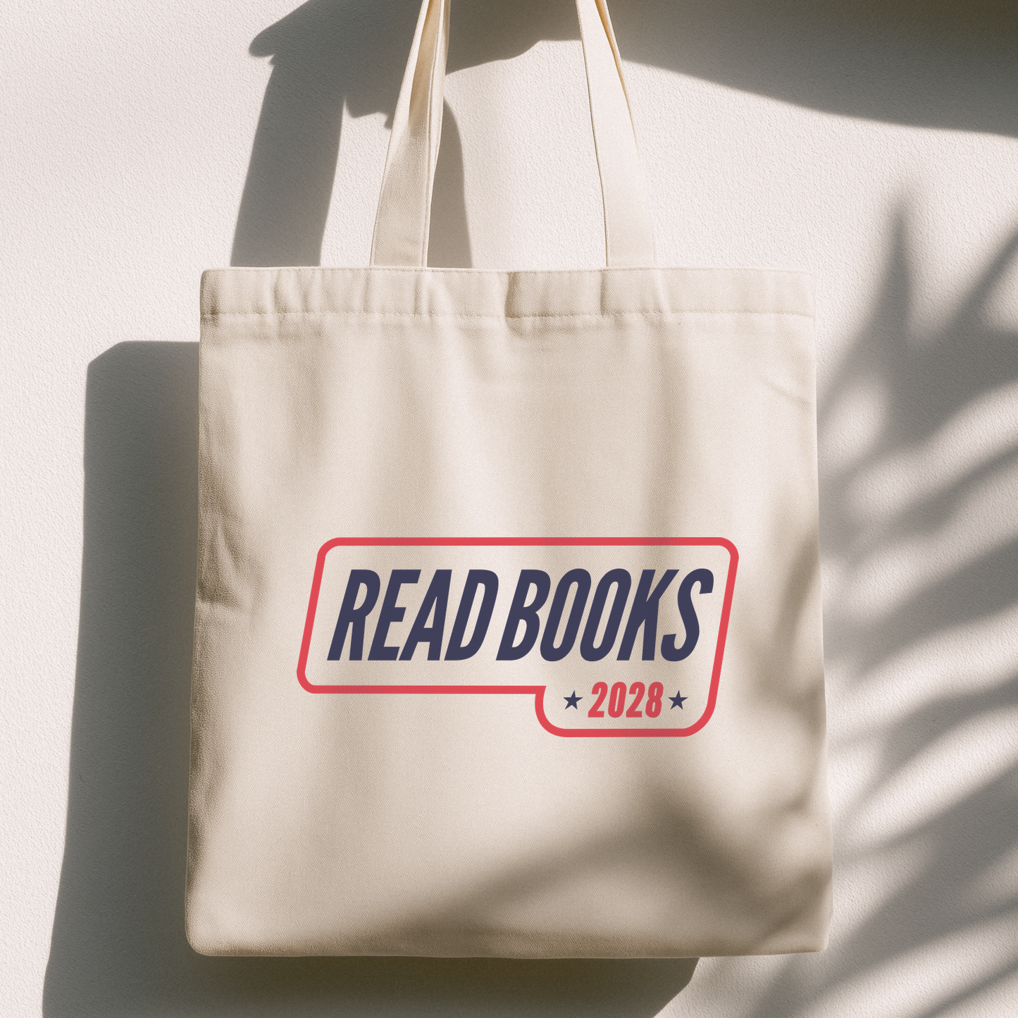 1. Lifestyle Mockup
    Read Books 2028 canvas tote bag hanging in natural light.