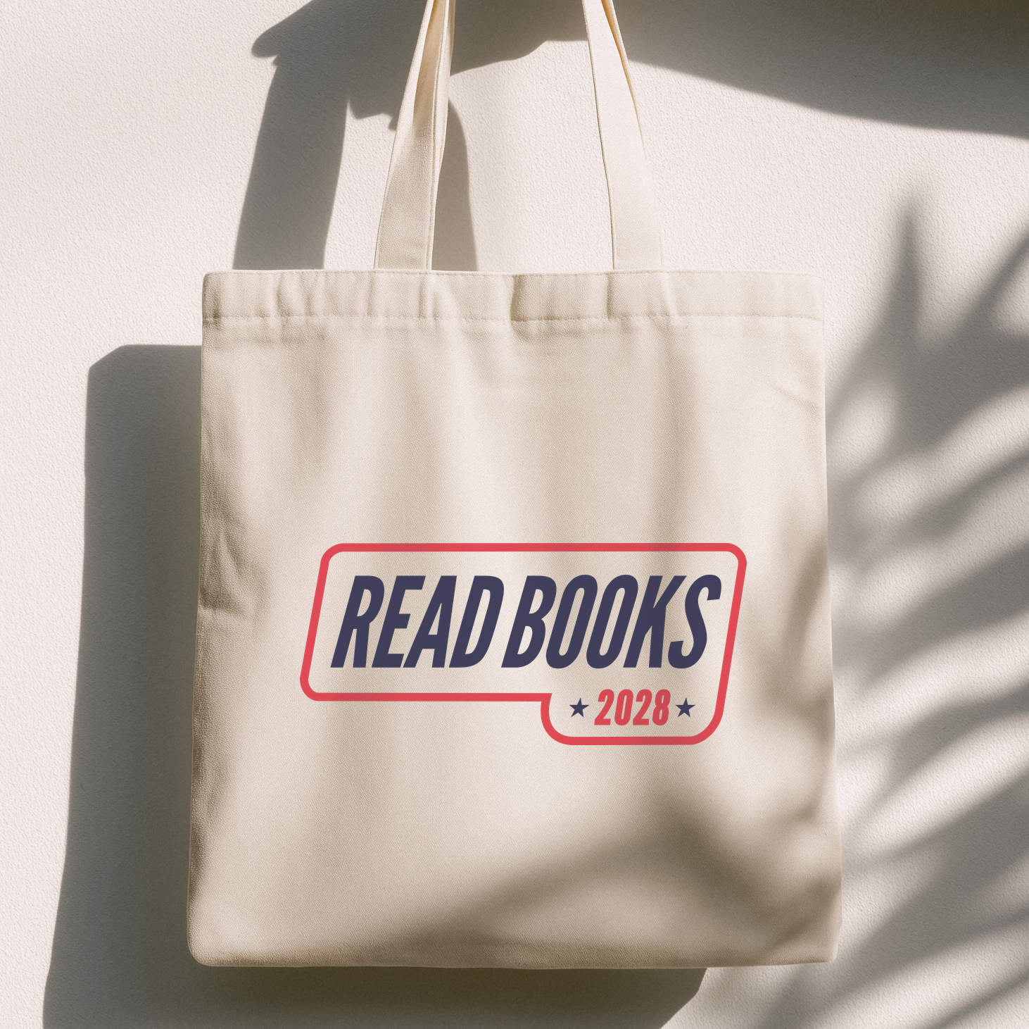 1. Lifestyle Mockup
    Read Books 2028 canvas tote bag hanging in natural light.