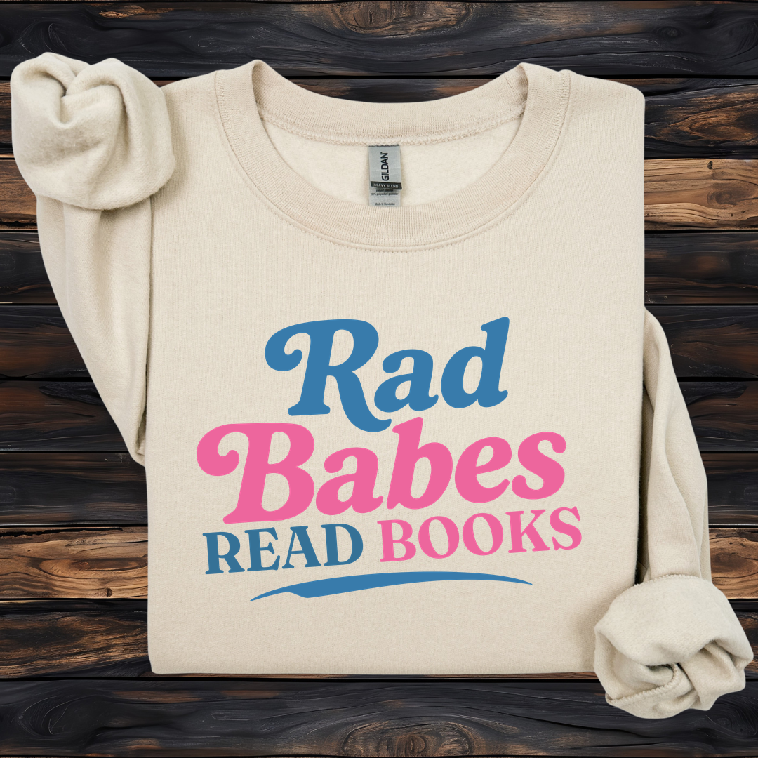 1. Main Image
    Rad Babes Read Books graphic sweatshirt on a sand Gildan crewneck.