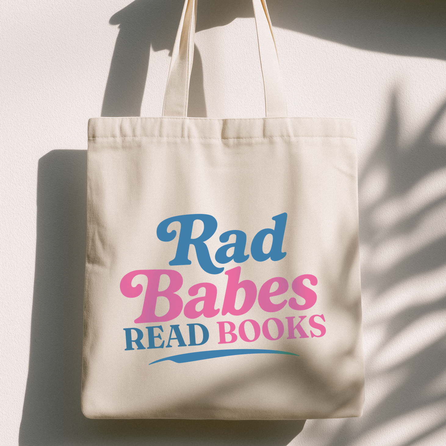 1. Lifestyle Mockup
Rad Babes Read Books canvas tote bag hanging in natural light.