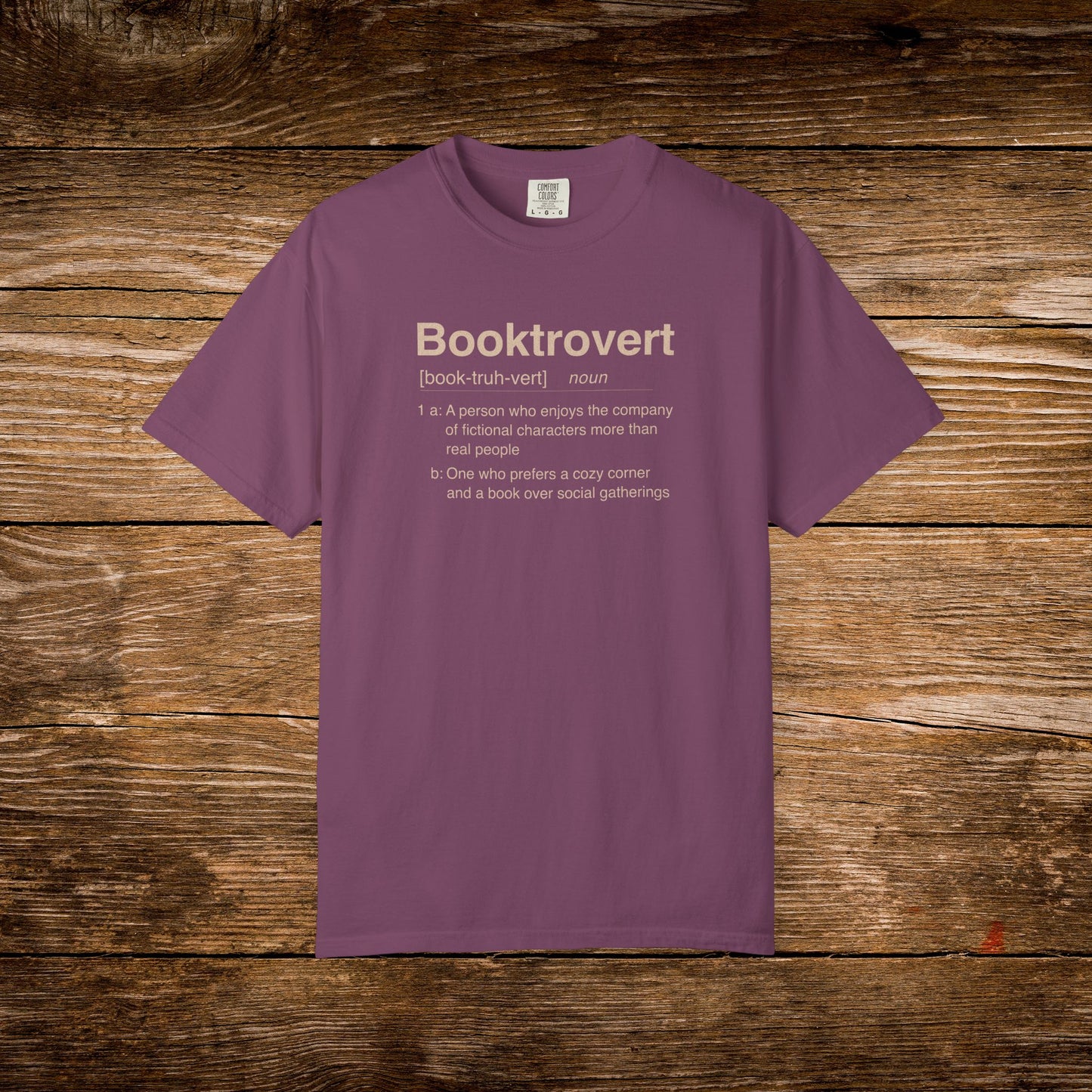 Booktrovert dictionary definition design printed on a berry Comfort Colors T-shirt.