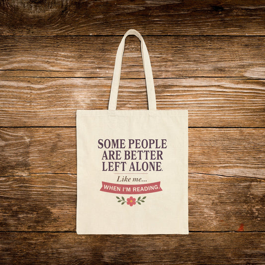 A cream-colored canvas tote bag with two handles, featuring the printed text 'SOME PEOPLE ARE BETTER LEFT ALONE. Like me.