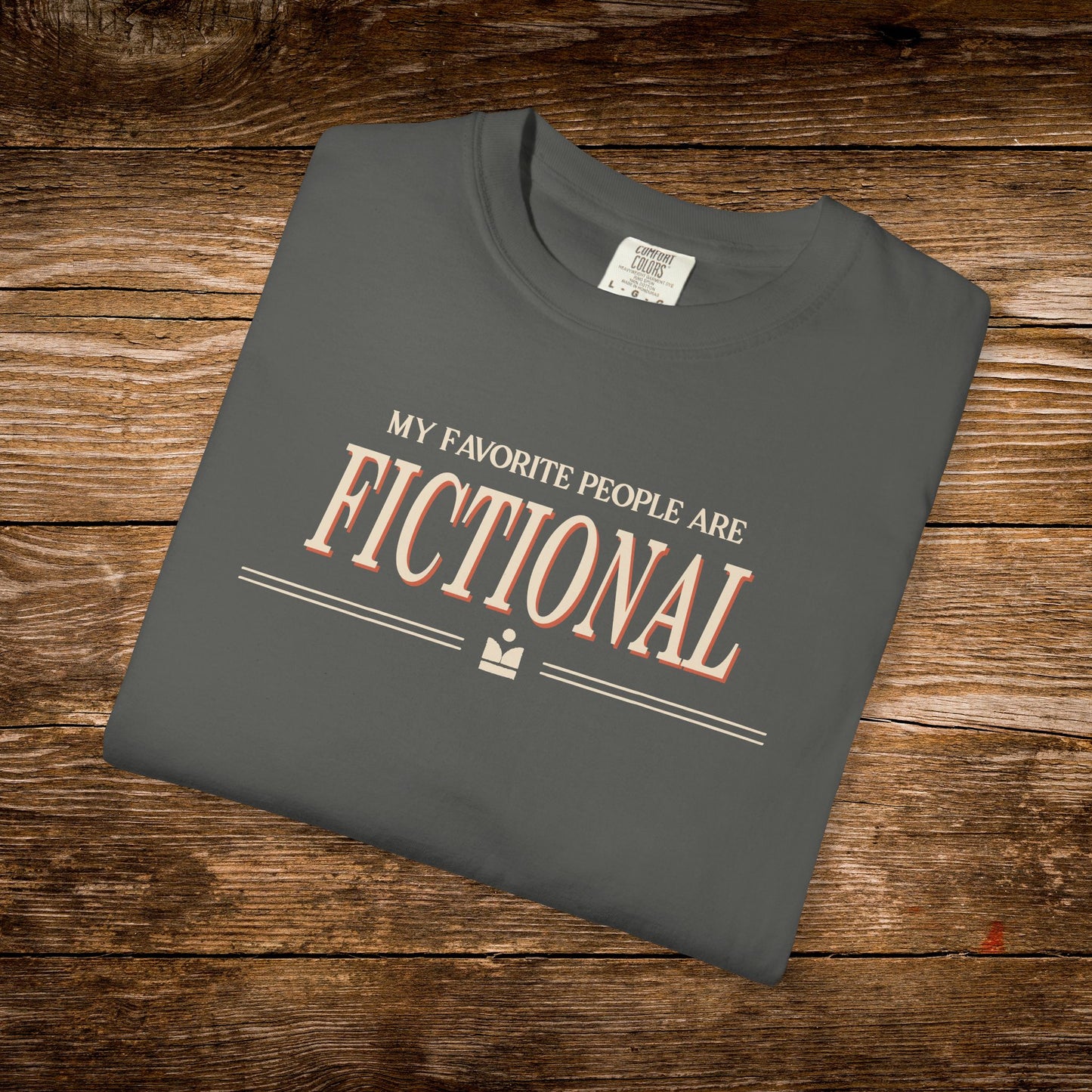 Folded gray t-shirt with text on a wooden surface