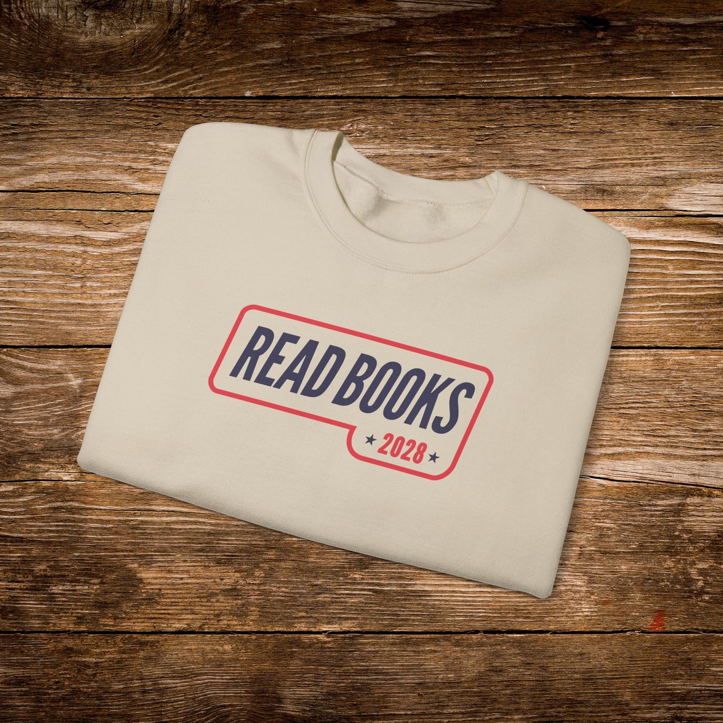 5. Folded Flat Lay
    Folded sand Read Books 2028 graphic sweatshirt.