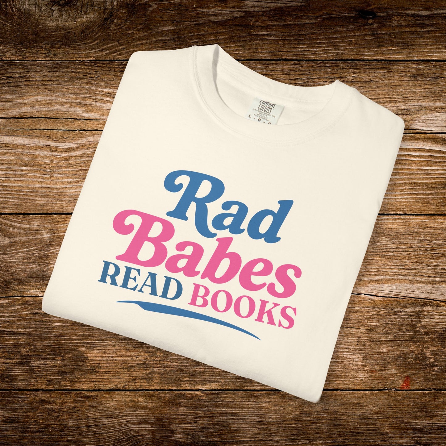5. Folded Flat Lay
    Folded ivory Rad Babes Read Books graphic t-shirt.