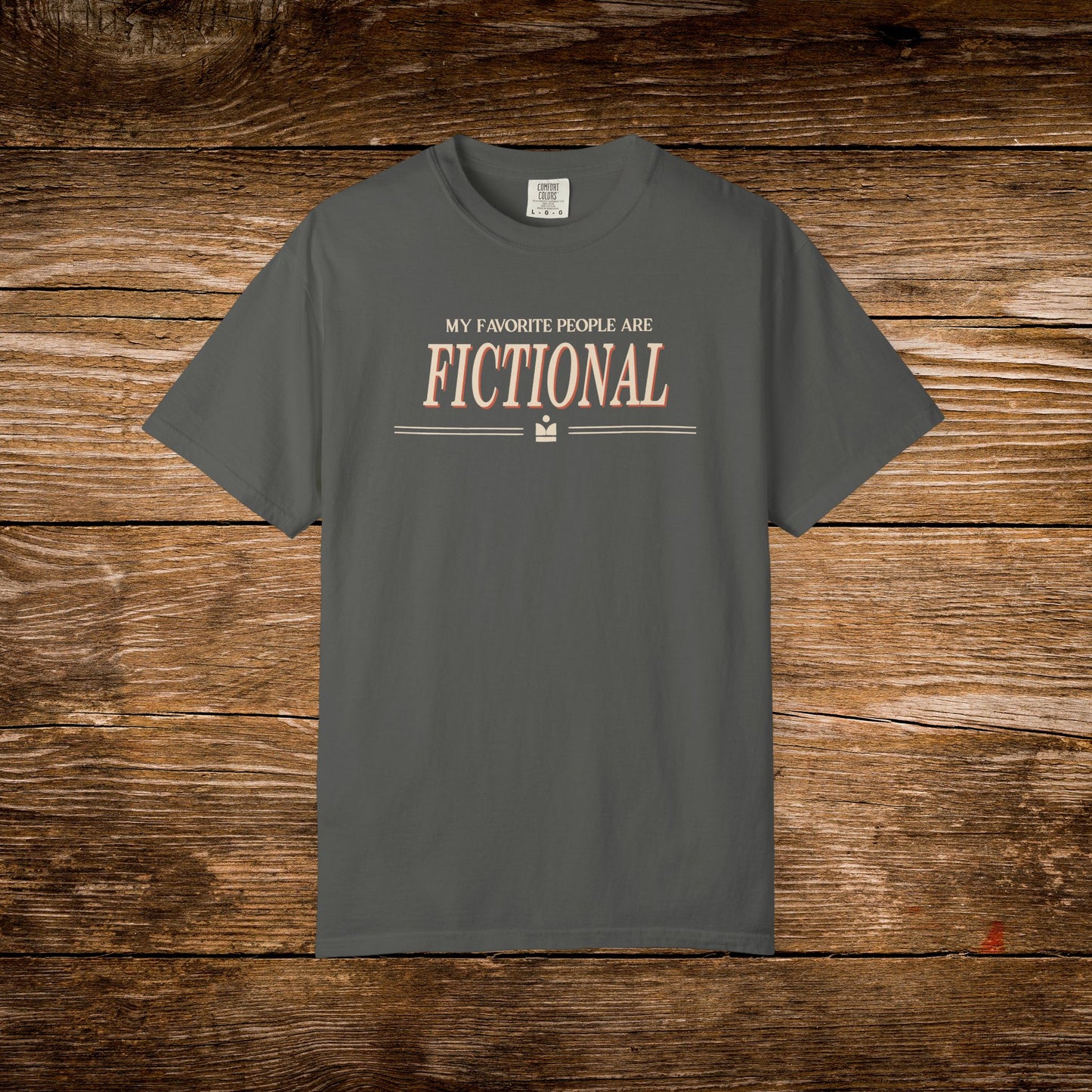 Gray t-shirt with 'My Favorite People Are Fictional' text on a wooden background