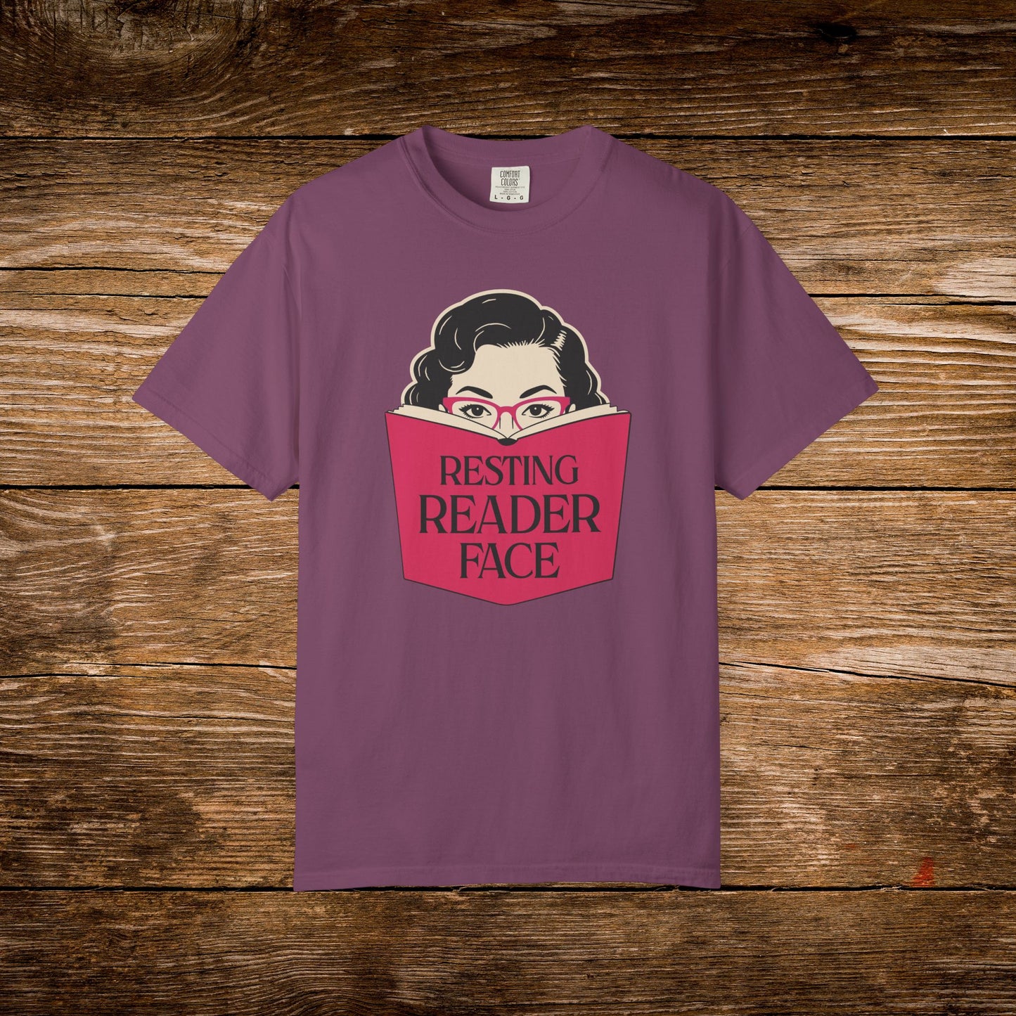 Resting Reader Face graphic t-shirt shown on a berry Comfort Colors tee.