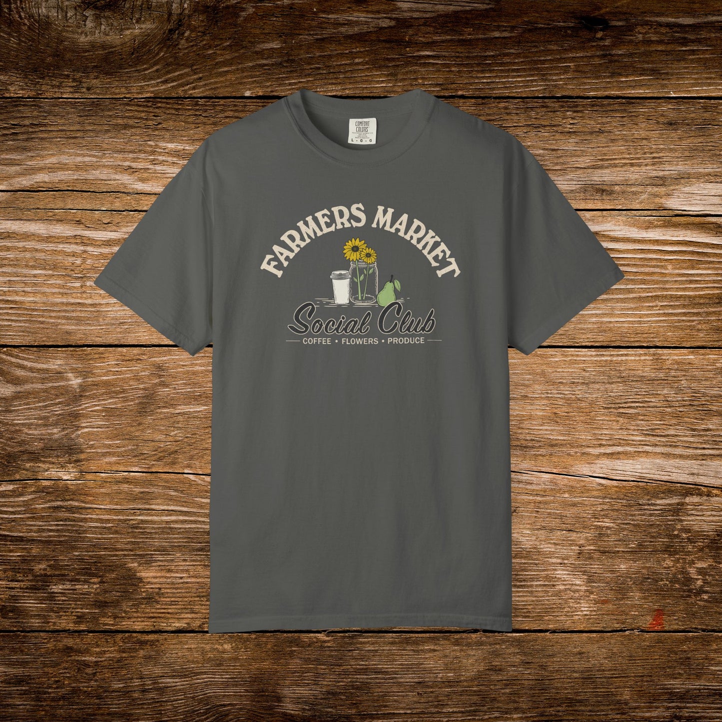 Gray t-shirt with text on a wooden surface