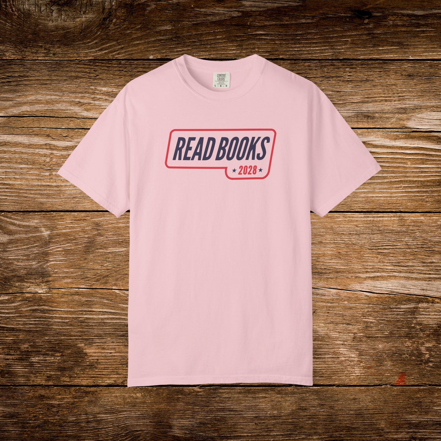 13. Blossom Shirt
    Read Books 2028 graphic t-shirt shown on a blossom Comfort Colors tee.