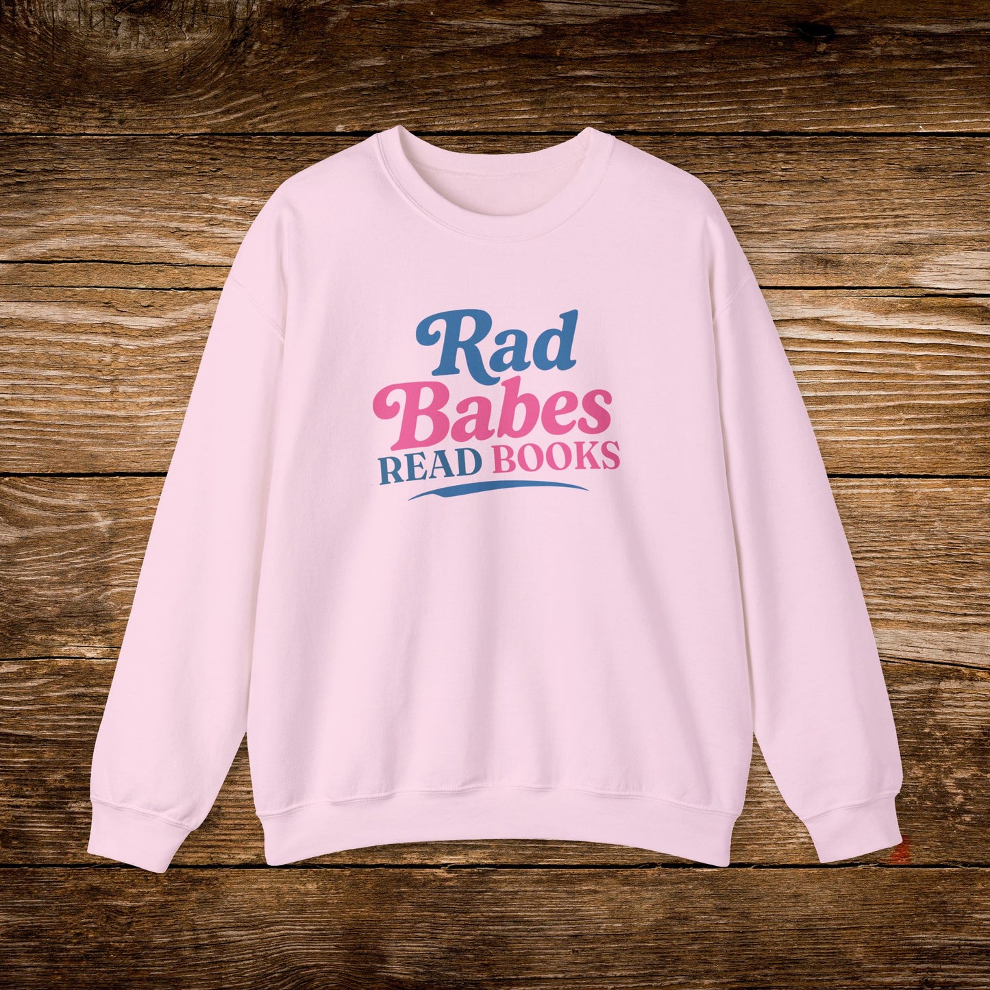 11. Light Pink Sweatshirt
    Rad Babes Read Books graphic sweatshirt shown on a light pink crewneck.
